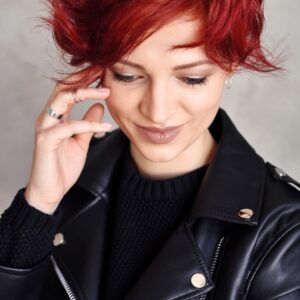Portrait of a beautiful young red-haired woman with short hair
